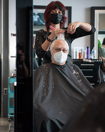 Image of a man getting his hair done