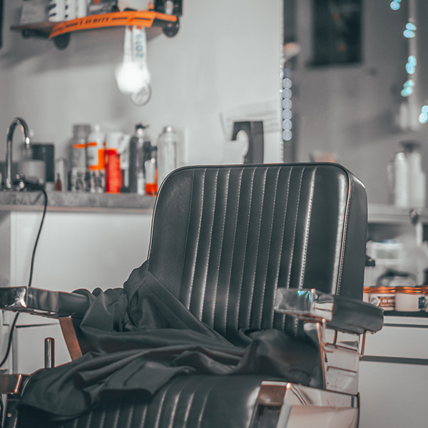 Empty black leather barber chair