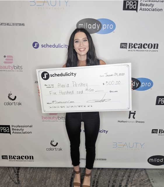 Woman holding a giant check for $500 dollars