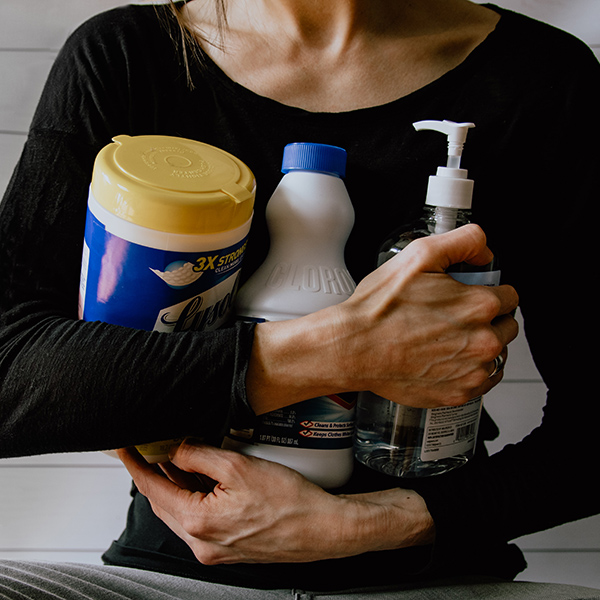 Image of woman holding cleaning products