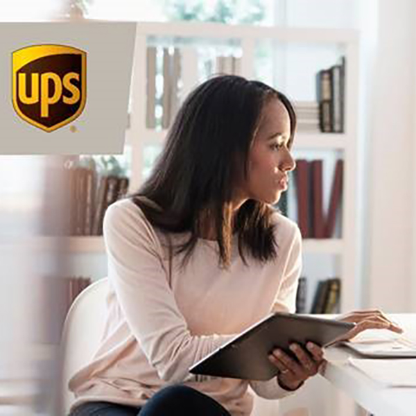 UPS logo woman sitting at a desk ordering online