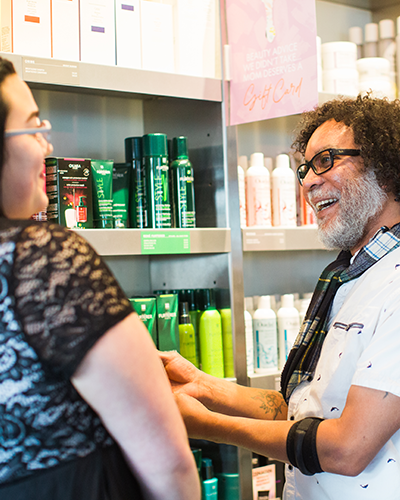 Image of two people speaking and smiling