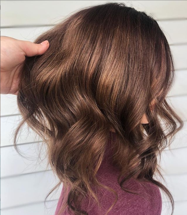 Brown hair styled and colour with copper highlights on a mannequin