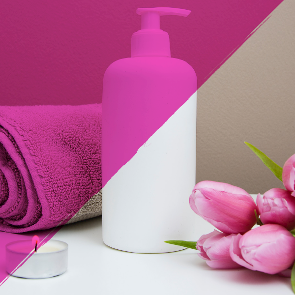 Shampoo bottle in a spa with tulips, towels, lotion and candle