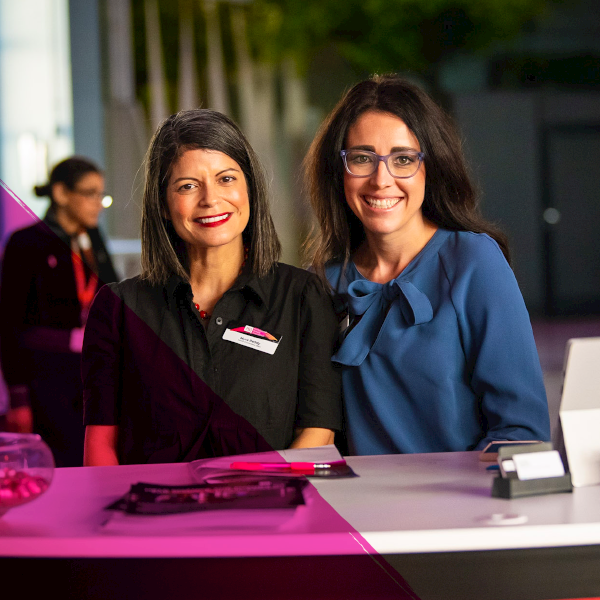 Two women concierge members sitting at a reception desk