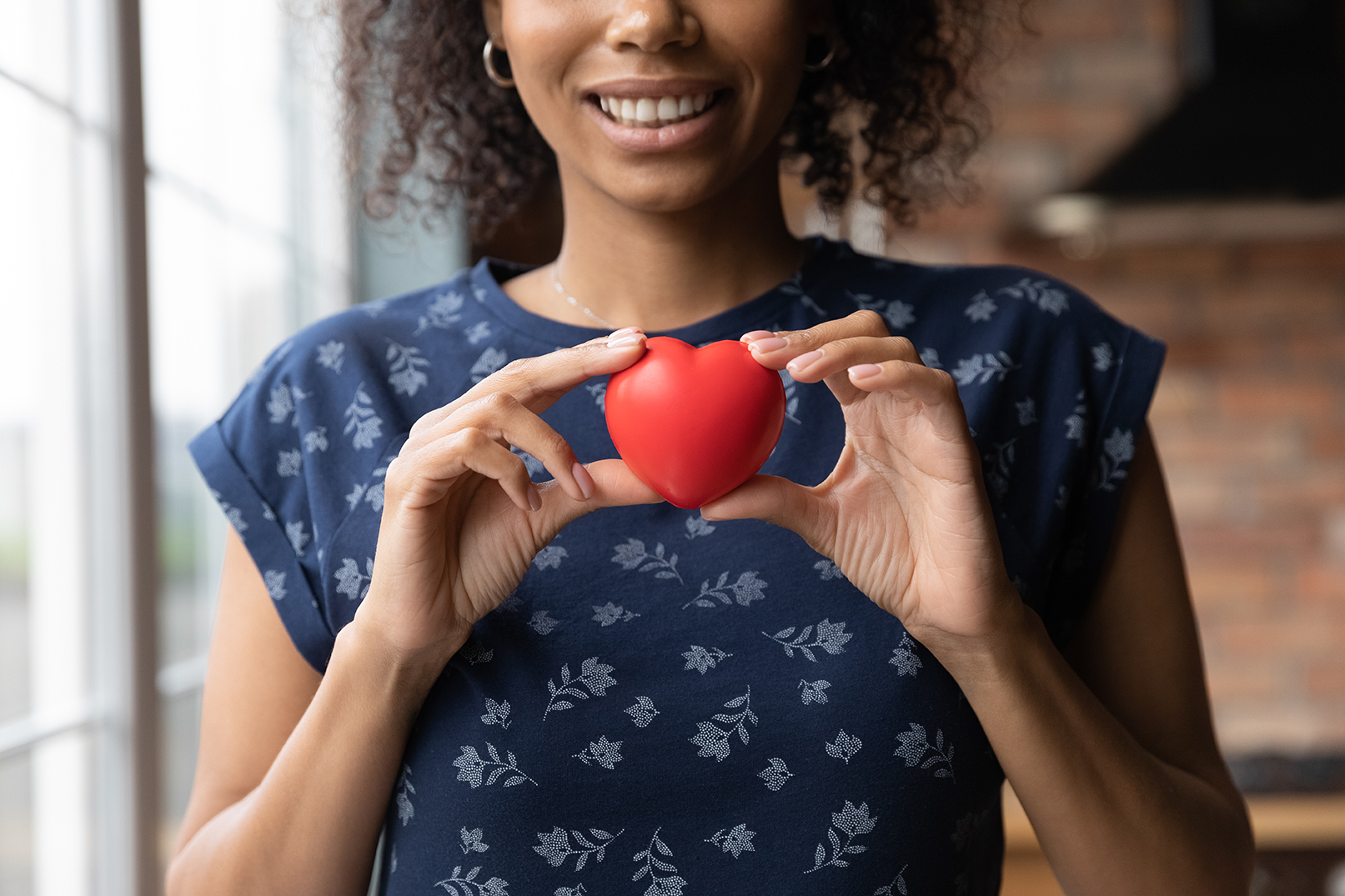 Image of a woman holding a toy heart