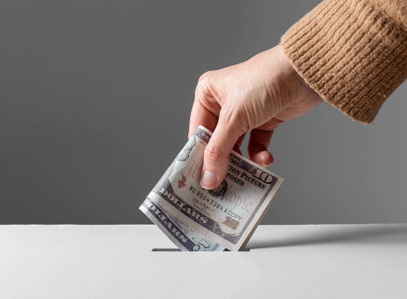 Image of someone holding cash