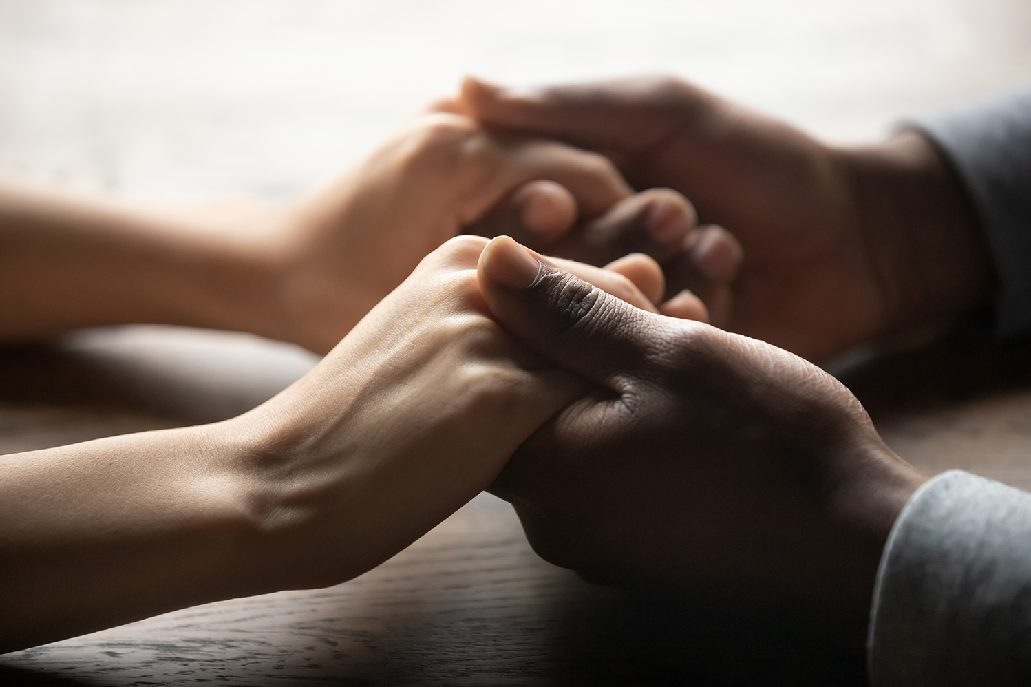 Image of two people holding hands