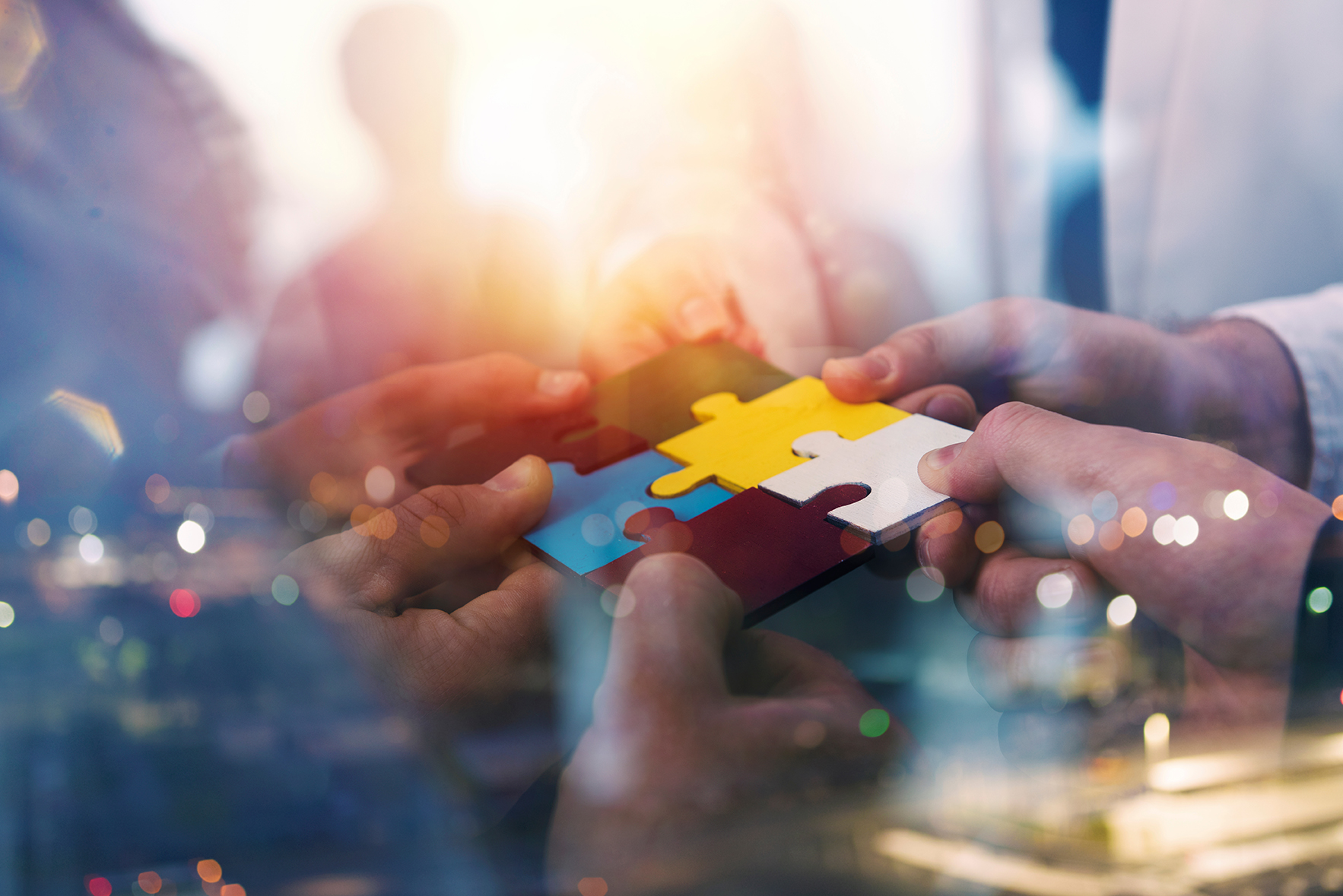 Image of people holding a piece of a puzzle