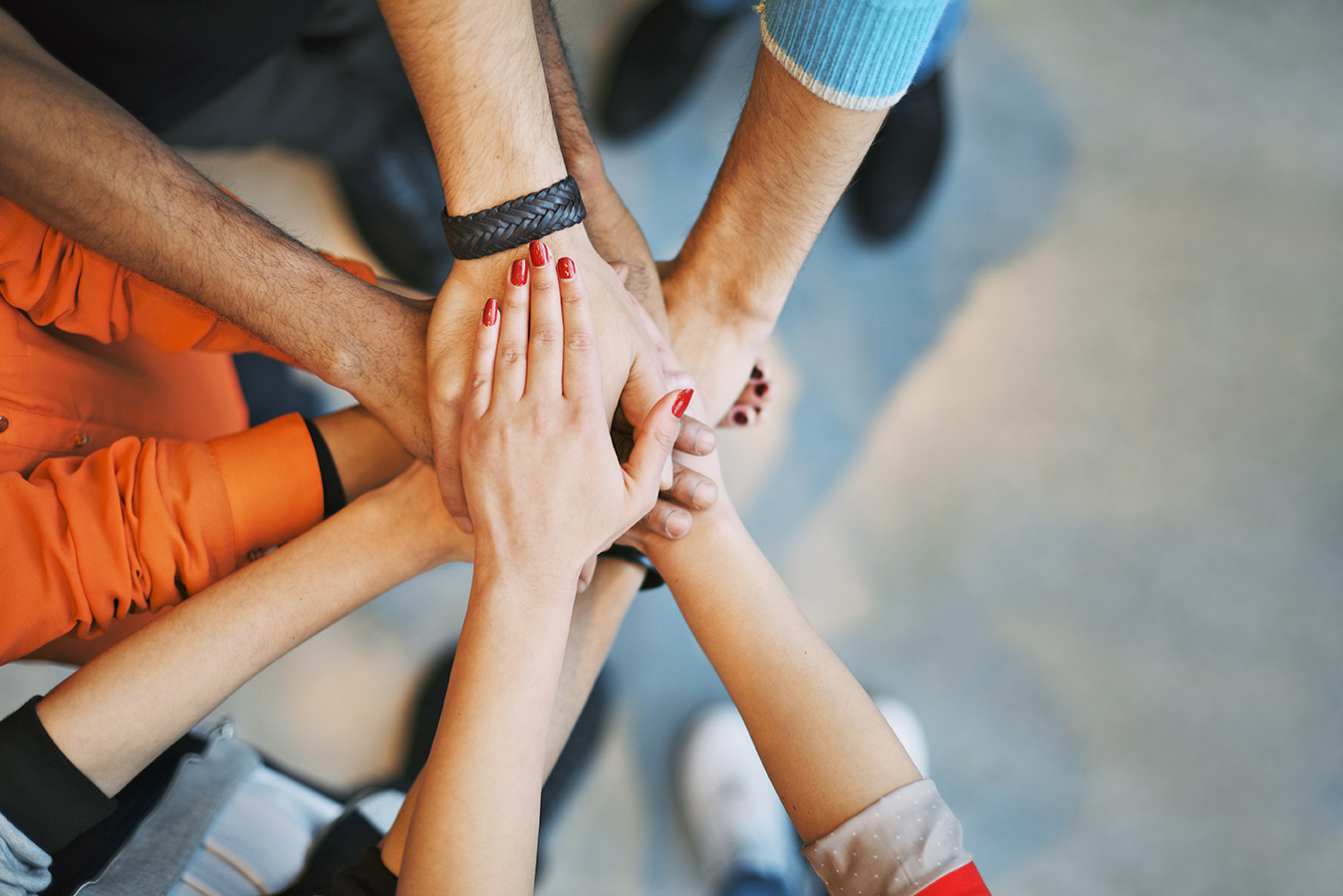 Image of people putting their hands in together