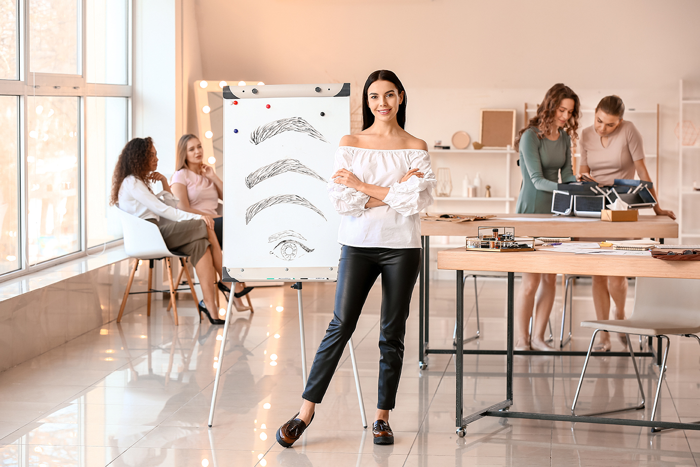 Image of a woman smiling with people working in the background