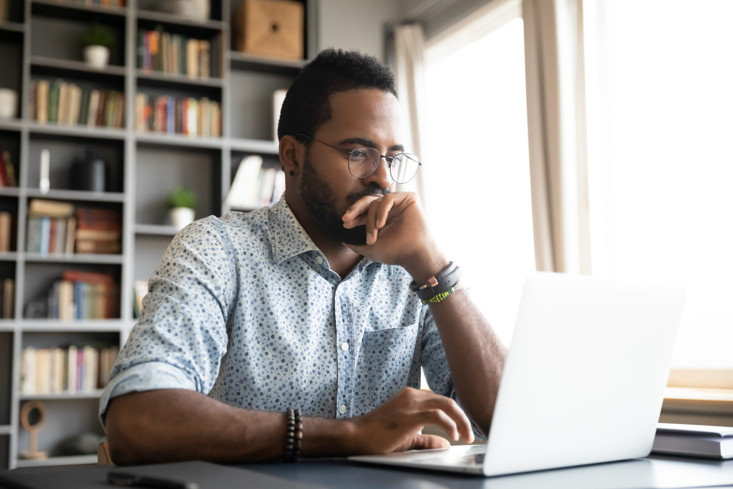 man searching computer for natural disaster resources